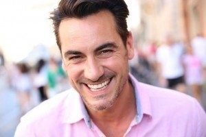 Client happy after he has had dental bridges service done in Ogden