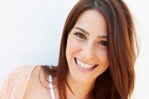 Younger woman smiling after she had dental bonding procedure done