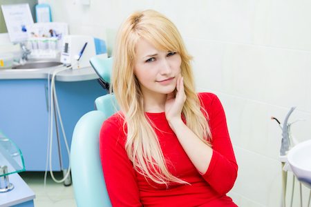 Dental professional examining a patient's mouth