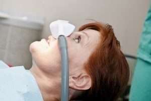 Woman patient receiving nitrous oxide as part of sedation dentistry services at Torghele Dentistry in Ogden UT.