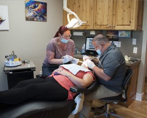 Dental hygienist Kristen works on a patient receiving preventive dentistry services on the Ogden UT office.